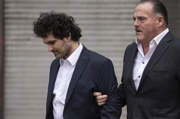 FTX founder Sam Bankman-Fried leaves court following his extradition to the U.S., Thursday, Dec. 22, 2022, in New York. Bankman-Fried's parents agreed to sign a $250 million bond and keep him at their California home while he awaits trial on charges that he swindled investors and looted customer deposits on his FTX trading platform. (AP Photo/Yuki Iwamura)