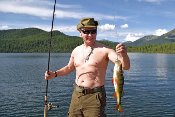 Putin holds a fish he caught during a mini-break in the Siberian Tyva region in this photo released by the Kremlin press service on Aug. 5, 2017. (Alexei Nikolsky, Sputnik, Kremlin Pool Photo via AP, File)