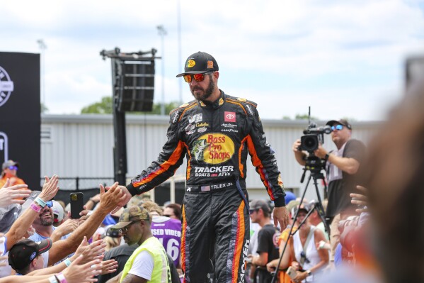 Martin Truex, Jr. interacts with fans during driver introductions for a NASCAR Cup Series auto race Sunday, July 30, 2023, in Richmond, Va. (AP Photo/Skip Rowland)