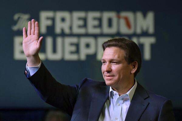 Florida Gov. Ron DeSantis waves to the crowd as he attends an event Friday, March 10, 2023, in Davenport, Iowa. (AP Photo/Ron Johnson)