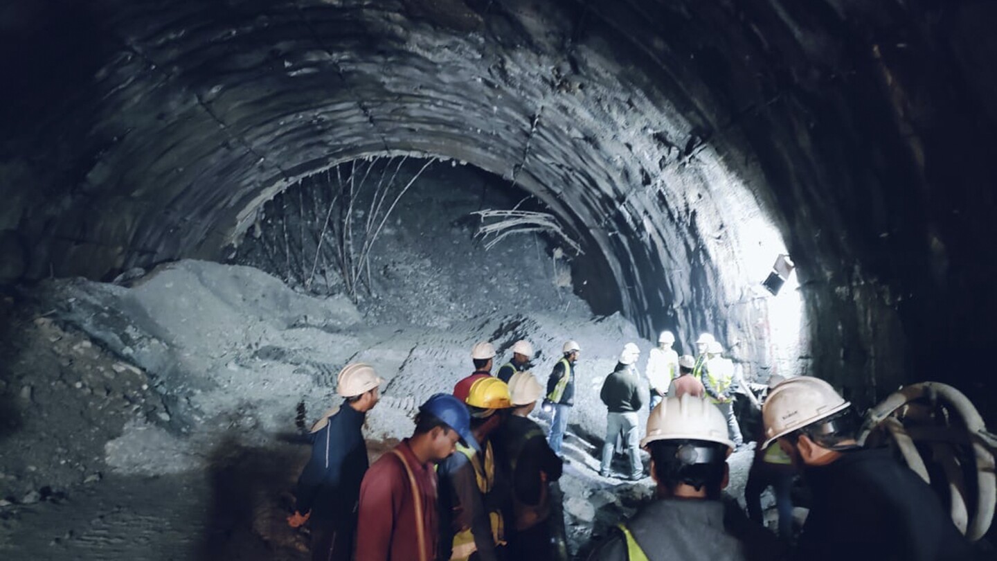 Rescuers dig to reach 40 workers trapped in collapsed road tunnel in north India