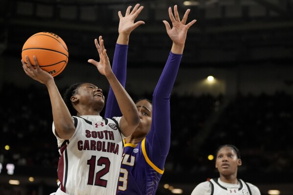 South Carolina guard MiLaysia Fulwiley shoots over LSU center Aalyah Del Rosario during the first half of an NCAA college basketball game at the Southeastern Conference women's tournament final Sunday, March 10, 2024, in Greenville, S.C. (AP Photo/Chris Carlson)