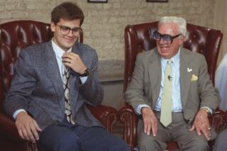 FILE - Hall of Fame baseball announcer Harry Caray, right, laughs with his grandson Chip in Chicago in this May 13, 1991 photo. Longtime broadcaster Chip Caray is taking over as the play-by-play voice of the St. Louis Cardinals, more than five decades after his grandfather and Hall of Fame broadcaster Harry Caray became a baseball staple with the same club. Bally Sports Midwest announced Caray’s hiring in a statement Monday, Jan. 30, 2023. (AP Photo/John Zich, file)