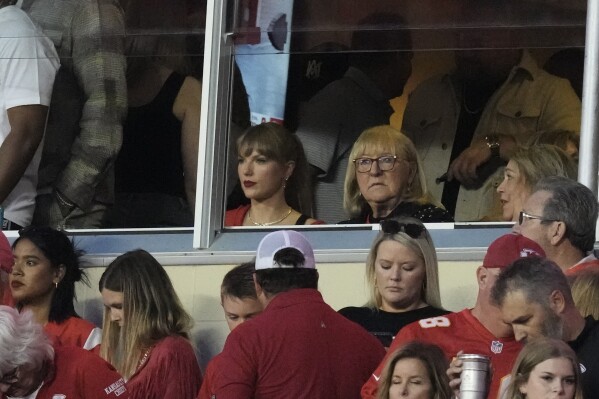 Taylor Swift and Donna Kelce watch wait for an NFL football game between the Kansas City Chiefs and the Denver Broncos, Thursday, Oct. 12, 2023, in Kansas City, Mo. (AP Photo/Charlie Riedel)