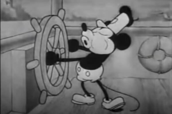 This still image from video provided by Disney shows the character Mickey Mouse in the 1928 animated short "Steamboat Willie." On Monday, Jan. 1, 2024, the iconic character from “Steamboat Willie” entered the public domain after the expiration of the 95-year copyright, and is already the focus of two horror films. (Disney via AP)