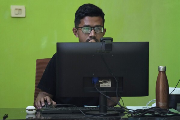 A former seminarian Arnoldus Yansen works on a computer at Ledalero Institute of Philosophy and Creative Technology in Maumere, East NusaTenggara province, Indonesia, Saturday, Aug. 24, 2024.(AP Photo/Tatan Syuflana)