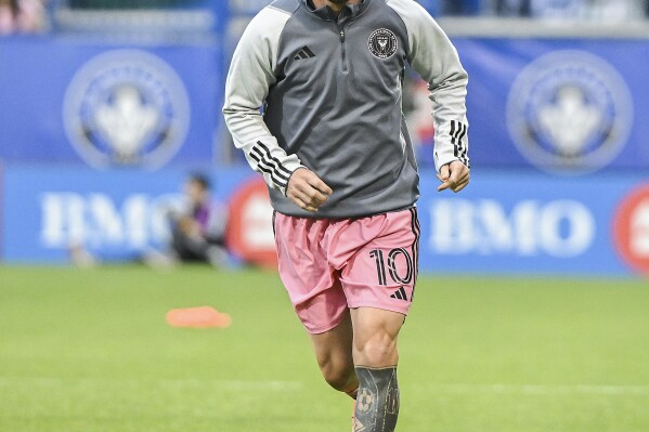 Inter Miami's Lionel Messi runs during warmups for the team's MLS soccer match against CF Montreal in Montreal, Saturday, May 11, 2024. (Graham Hughes/The Canadian Press via AP)
