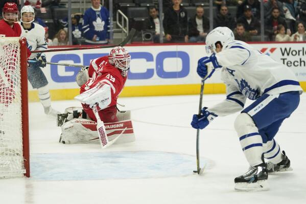 Toronto Maple Leafs right wing Mitchell Marner (16) scores on Detroit Red Wings goaltender Alex Nedeljkovic (39) in the third period of an NHL hockey game Saturday, Feb. 26, 2022, in Detroit. (AP Photo/Paul Sancya)