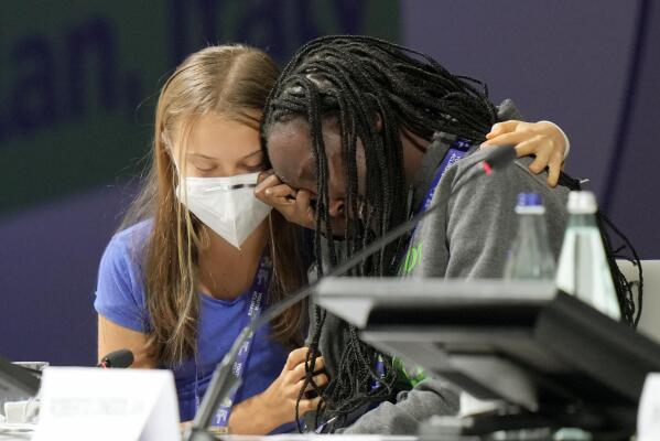 Ugandan climate activist Vanessa Nakate, right, is comforted by Swedish activist Greta Thunberg as she is overcome by emotion after speaking at the opening of a three-day Youth for Climate summit in Milan, Italy, Tuesday, Sept. 28, 2021.(AP Photo/Luca Bruno)