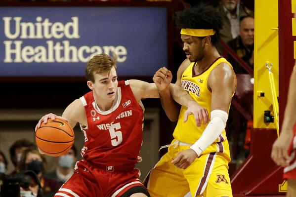 Wisconsin forward Tyler Wahl (5) drives on Minnesota forward Eric Curry during the first half of an NCAA college basketball game Wednesday, Feb. 23, 2022, in Minneapolis. (AP Photo/Andy Clayton-King)