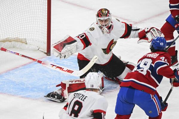 Ottawa Senators goaltender Mads Sogaard (40) loses his stick as Montreal Canadiens' Rafael Harvey-Pinard (49) moves in during the first period of an NHL hockey game Saturday, Feb. 25, 2023, in Montreal. (Graham Hughes/The Canadian Press via AP)