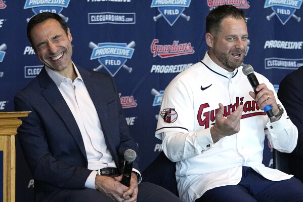 Chris Antonetti, left, president of baseball operations for the Cleveland Guardians, laughs as Stephen Vogt, center, speaks during a news conference introducing him as the manager of the Cleveland Guardians at a news conference Friday, Nov. 10, 2023, in Cleveland. (AP Photo/Sue Ogrocki)