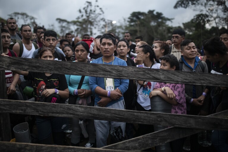 Migrants planning to start walking across the Darien Gap from Colombia to Panama in hopes of reaching the U.S. gather at the trailhead camp in Acandi, Colombia, Tuesday, May 9, 2023.  (AP Photo/Ivan Valencia)