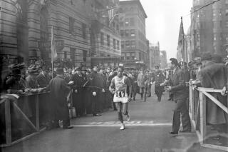 FILE — Ellison M. "Tarzan" Brown, a 22-year-old a member of Rhode Island's Narragansett tribe, breaks the tape to win the 40th annual Boston Marathon, in Boston, in this April 19, 1936, file photo. Organizers of the Boston Marathon are seeking to make amends for running the 125th edition on Indigenous Peoples Day by throwing the spotlight on Brown, who won the race twice in the 1930s and inspired the name "Heartbreak Hill." The Boston Athletic Association said Monday, Sept. 27, 2021, it will honor Brown's legacy at the pandemic-altered Oct. 11 running of the race. (AP Photo/File)