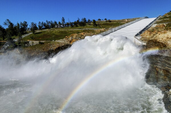 FILE - Water rushes out of the Oroville Spillway at Lake Oroville on March 26, 2023, in Butte County, Calif. California ended its 2022-23 water year on Saturday, Sept. 30, 2023. After years of severe drought, the reservoirs in the state water project ended the year at 128% of their historical average. That includes Lake Oroville. (AP Photo/Noah Berger, File)