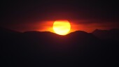 The sun sets behind the Rocky Mountains after daytime high temperatures reached above 90-degrees, Monday, June 26, 2023, in Denver. Forecasters predict that the hot weather will continue until midweek when a front packing rain sweeps over the intermountain West. (AP Photo/David Zalubowski)