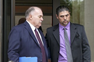 Gino DiGiovanni Jr., 42, and his attorney, Martin Minnella, walk outside the federal courthouse in New Haven, Conn. Aug. 15, 2023. DiGiovanni faces four misdemeanor charges from the U.S. Attorney's Office in the District of Columbia in connection with his actions during the U.S. Capitol riot on Jan. 6, 2021. (Peter Yankowski/Hearst Connecticut Media via AP)