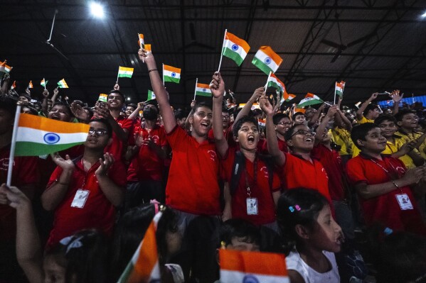 Schoolchildren celebrate the successful landing of spacecraft Chandrayaan-3 on the moon, in a school in Guwahati, India, Wednesday, Aug. 23, 2023. (AP Photo/Anupam Nath)