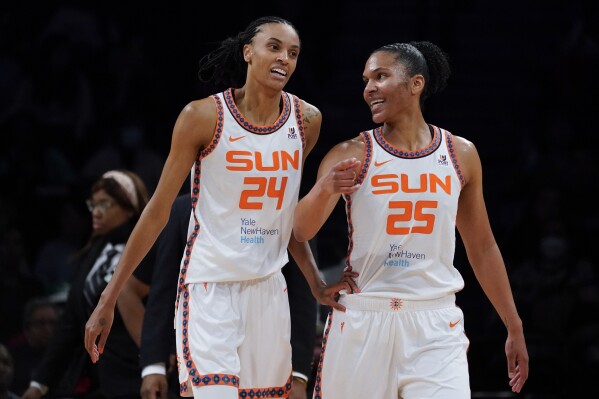 FILE - Connecticut Sun forward DeWanna Bonner (24) and forward Alyssa Thomas (25) speak during a time out in the first half during a WNBA basketball game against the New York Liberty, Tuesday, May 17, 2022, in New York. Bonner and Thomas have found a comfortable work-life balance in the WNBA. They are the unquestioned leaders of the Sun on the court and life partners off of it. (AP Photo/John Minchillo, File)