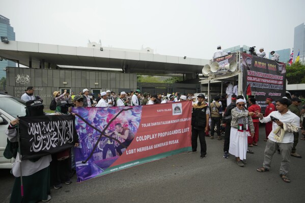 Muslims gather for a rally against British band Coldplay outside the British embassy in Jakarta, Indonesia, Friday, Nov. 10, 2023. Dozens of conservative Muslims marched in Indonesia's capital on Friday calling for cancellation of Coldplay's concert later this month, saying the British band's support of lesbian, gay, bisexual, and transgender will corrupt young people. (AP Photo/Achmad Ibrahim)