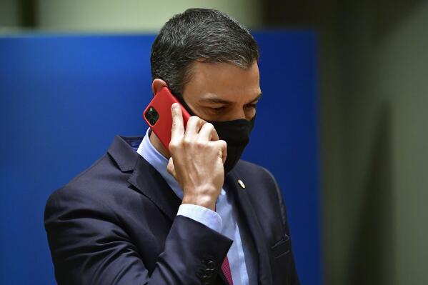 FILE - Spain's Prime Minister Pedro Sanchez speaks on his cell phone during a round table meeting at an EU summit in Brussels, on July 20, 2020. Spain’s government has fired the director of its top intelligence agency amid two separate cases of the hacking of politicians’ cellphones, Spanish media reports said Tuesday. (John Thys, Pool Photo via AP, File)