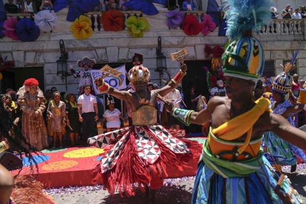 Performers dance prior to a ceremony that marks the official start of Carnival in Rio de Janeiro, Brazil, Friday, Feb. 9, 2024. (AP Photo/Silvia Izquierdo)