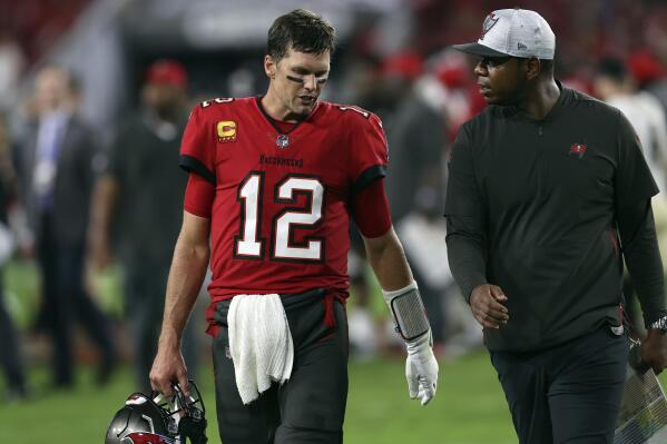Tampa Bay Buccaneers quarterback Tom Brady (12) leaves the field with offensive coordinator Byron Leftwich after the team lost to the New Orleans Saints during an NFL football game Sunday, Dec. 19, 2021, in Tampa, Fla. (AP Photo/Mark LoMoglio)