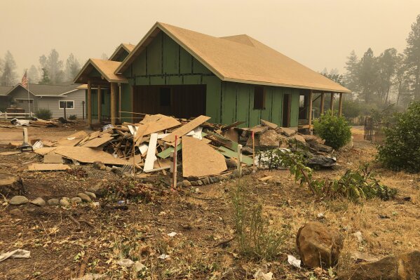 A home under construction in Paradise, Calif., on Thursday, Sept. 10, 2020. Most of the buildings in Paradise were destroyed in a 2018 wildfire. The town had a population of more than 26,000. But two years after the fire more than 4,000 people live there now, according to local leaders. The town has issued 1,051 building permits for single family homes and 347 of them have been rebuilt and issued certificates of occupancy. But a nearby wildfire has darkened the skies in Paradise again, serving as a reminder of the dangers of living there. (AP Photo/Adam Beam)