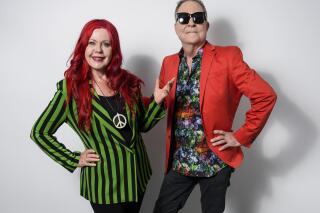FILE - Kate Pierson, left, and Fred Schneider, of The B-52s, pose for a portrait in New York on  June 21, 2018. The quirky dance-pop outfit The B-52s are hitting the road one last time for a final tour this summer that will roam from coast to coast. (Photo by Christopher Smith/Invision/AP, File)