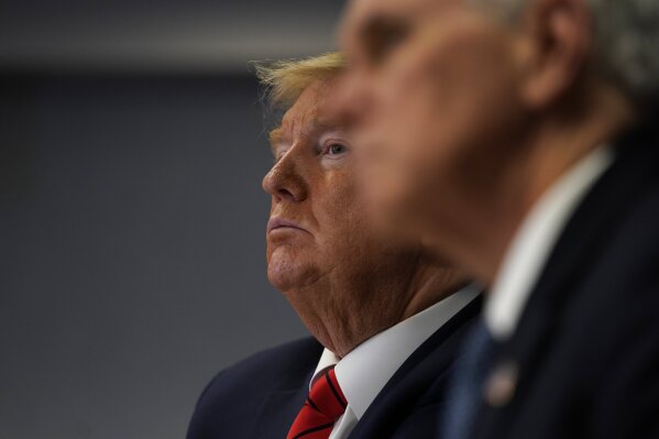President Donald Trump attends a teleconference with governors at the Federal Emergency Management Agency headquarters, Thursday, March 19, 2020, in Washington. Vice President Mike Pence is at right. (AP Photo/Evan Vucci, Pool)