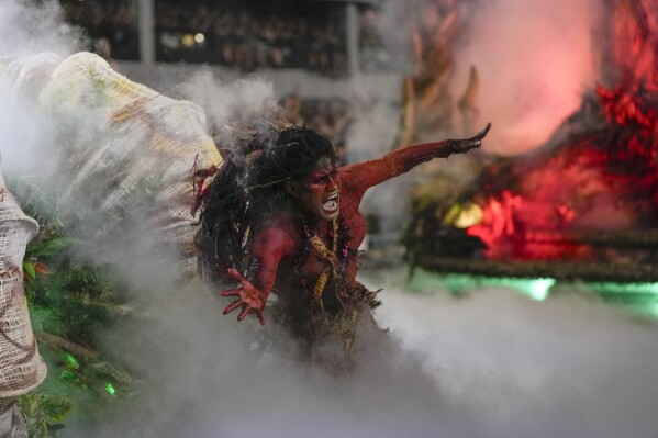 A performer from the Salgueiro samba school parades during Carnival celebrations at the Sambadrome in Rio de Janeiro, Brazil, Monday, Feb. 12, 2024. (AP Photo/Silvia Izquierdo)