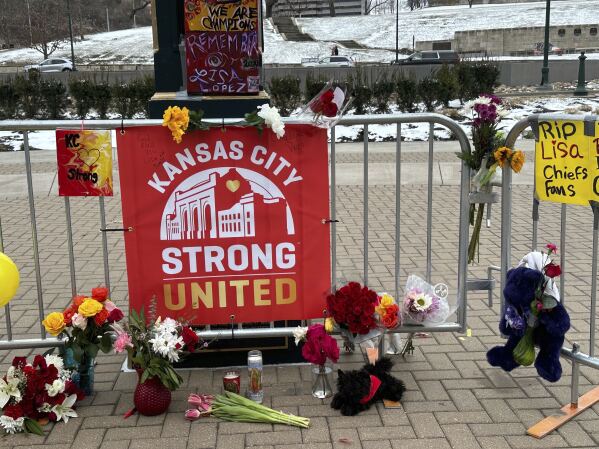 Flowers, signs and other items are gathered in front of Union Station on Friday, Feb. 16, 2024, in Kansas City, Mo. The memorial is for the victims of a shooting that took place following a Kansas City Chiefs Super Bowl victory rally on Wednesday. (AP Photo/Nick Ingram)