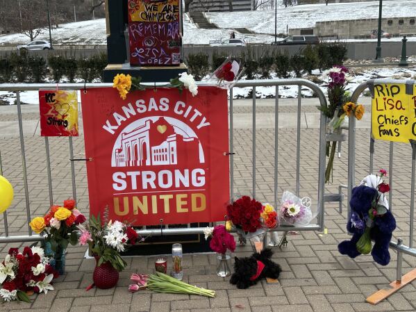 Flowers, signs and other items are gathered in front of Union Station on Friday, Feb. 16, 2024, in Kansas City, Mo. The memorial is for the victims of a shooting that took place following a Kansas City Chiefs Super Bowl victory rally on Wednesday. (AP Photo/Nick Ingram)