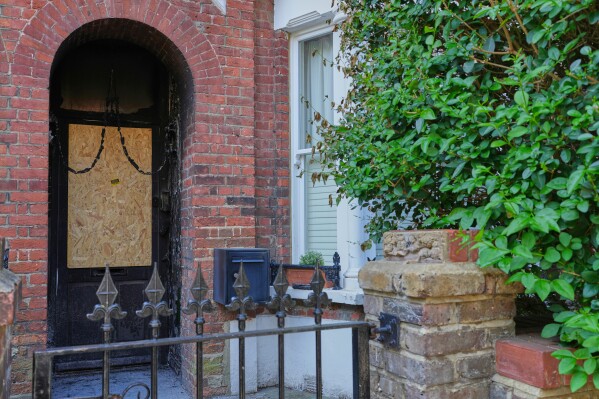 Fire damage is seen in the doorway of a house belonging to British Prime Minister Keir Starmer in Kentish Town in London, Tuesday, May 13, 2025. (AP Photo/Kirsty Wigglesworth)