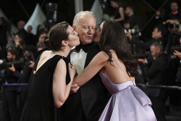 Inga Ibsdotter Lilleaas, from left, Stellan Skarsgard and Renate Reinsve pose for photographers upon departure from the premiere of the film 'Sentimental Value' at the 78th international film festival, Cannes, southern France, Wednesday, May 21, 2025. (Photo by Lewis Joly/Invision/AP)