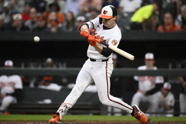 Baltimore Orioles' Gunnar Henderson swings for a grand slam against the Boston Red Sox during the second inning of a baseball game Wednesday, May 29, 2024, in Baltimore. (AP Photo/Nick Wass)