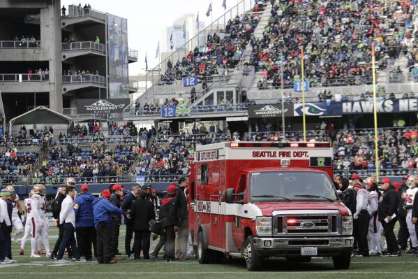San Francisco 49ers running back Trenton Cannon is loaded into an ambulance after an injury during the first half of an NFL football game against the Seattle Seahawks at Lumen Field, Sunday, Dec. 5, 2021, in Seattle. (AP Photo/John Froschauer)