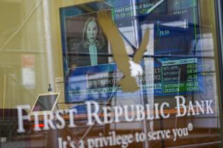 FILE - A television screen displaying financial news, including the stock price of First Republic Bank, is seen inside one of the bank's branches in New York's Financial District, on March 16, 2023. Customers of the bank pulled more than $100 billion in deposits out of the bank during the March crisis, as fears swirled that it could be the third bank to fail after the collapse of Silicon Valley Bank and Signature Bank. (AP Photo/Mary Altaffer, File)