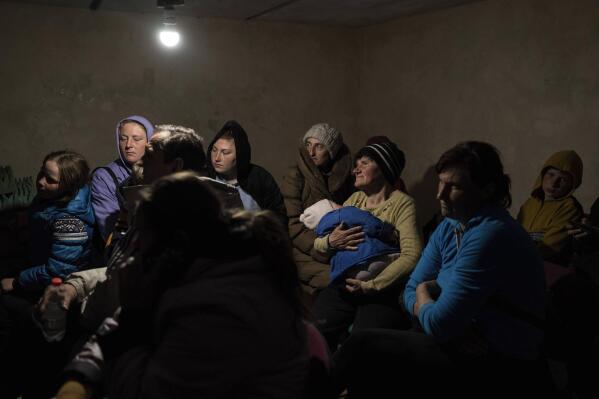 People who fled villages attacked by the Russian army hide in the basement of a church in Bashtanka, Mykolaiv district, Ukraine, on Thursday, March 31, 2022. (AP Photo/Petros Giannakouris)