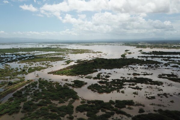 
              This photo issued Tuesday March 19, 2019, taken within last week and supplied by World Food Programme,  flood waters cover large tracts of land in Nicoadala, Zambezia Province of Mozambique. Rapidly rising floodwaters have created "an inland ocean" in the country endangering many thousands of families, as aid organizations scramble to rescue and provide food to survivors of Cyclone Idai. (Photo World Food Programme via AP)
            