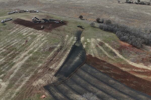 A crew applies biosolids, also known as sewage sludge, to a field, Monday, Feb. 17, 2025, in Wellston, Okla. (AP Photo/Joshua A. Bickel)