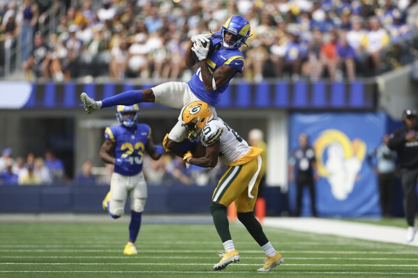 Los Angeles Rams wide receiver Demarcus Robinson (15) catches a pass over Green Bay Packers cornerback Keisean Nixon (25) during the first half of an NFL football game Sunday, Oct. 6, 2024, in Inglewood, Calif. (AP Photo/Ryan Sun)
