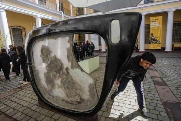 A sculpture depicting half of a pair of black-framed glasses Chilean President Salvador Allende was wearing when he died, is displayed in the patio of the National Museum of History in Santiago, Chile, Thursday, Sept. 7, 2023. Gen. Augusto Pinochet led a military coup on Sept. 11, 1973, that included the bombing of the presidential palace in the capital of Santiago, where Allende had taken refuge. Allende died by suicide during the assault. (AP Photo/Esteban Felix)