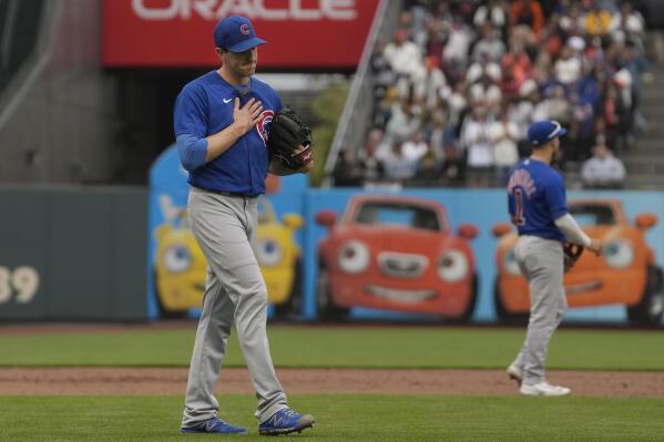 Chicago Cubs pitcher Kyle Hendricks, left, reacts after a double hit by San Francisco Giants' Mitch Haniger during the eighth inning of a baseball game in San Francisco, Saturday, June 10, 2023. (AP Photo/Jeff Chiu)
