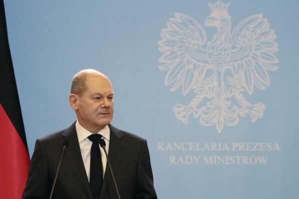 FILE - Germany's new chancellor, Olaf Scholz addresses the media during a joint press conference with Polish Prime Minister Mateusz Morawiecki in Warsaw, Poland, Sunday, Dec. 12, 2021. Poland conservative ruling party has used Germany's Chancellor Olaf Scholz and the German Embassy in negative light in its campaign ahead of crucial parliamentary elections in which it wants to hold on to power. In a campaign spot released Monday, Poland's key politician, ruling party leader Jaroslaw Kaczynski pretends to reject a call from Scholz, in a sham gesture of political independence from European Union's leading country. (AP Photo/Czarek Sokolowski, File)