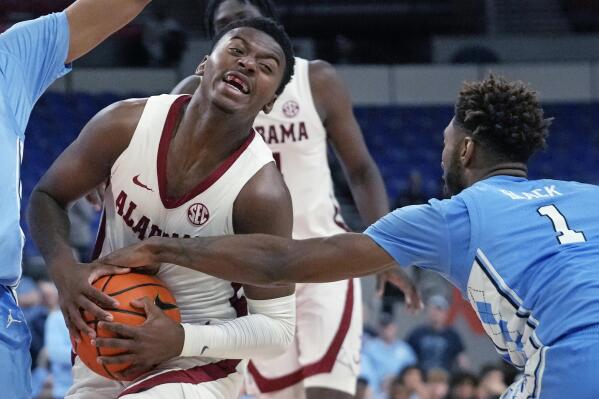 North Carolina forward Leaky Black (1) fouls Alabama guard Jaden Bradley, left, during the first half of an NCAA college basketball game in the Phil Knight Invitational on Sunday, Nov. 27, 2022, in Portland, Ore. (AP Photo/Rick Bowmer)