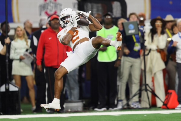 Texas wide receiver Matthew Golden catches a pass against Ohio State during the second half of the Cotton Bowl College Football Playoff semifinal game, Friday, Jan. 10, 2025, in Arlington, Texas. (AP Photo/Gareth Patterson, File)