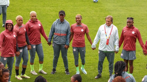 Nigeria women's national team head coach Randy Waldrum, second right, stands with his players and staff for a prayer ahead of a practice session in Brisbane, Australia, Tuesday, July 18, 2023. Nigeria will play Canada in their opening Women's World Cup game in Melbourne on July 21. (AP Photo/Katie Tucker)