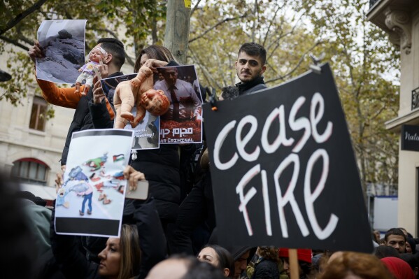 People demonstrate in a show of solidarity with Palestinian people Saturday, Oct. 28, 2023 in Paris. Israel on Saturday expanded its ground operation in Gaza, sending in tanks and infantry backed by massive strikes from the air and sea. (AP Photo/Thomas Padilla)