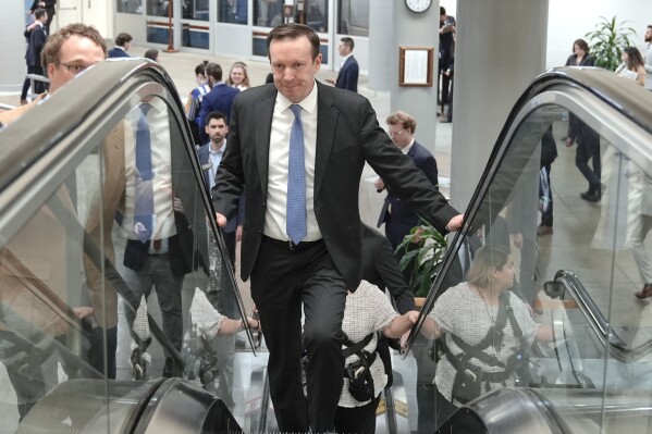 Sen. Chris Murphy, D-Conn., rides an escalator at the Senate subway on Capitol Hill Tuesday, March 12, 2024, in Washington. (AP Photo/Mariam Zuhaib)